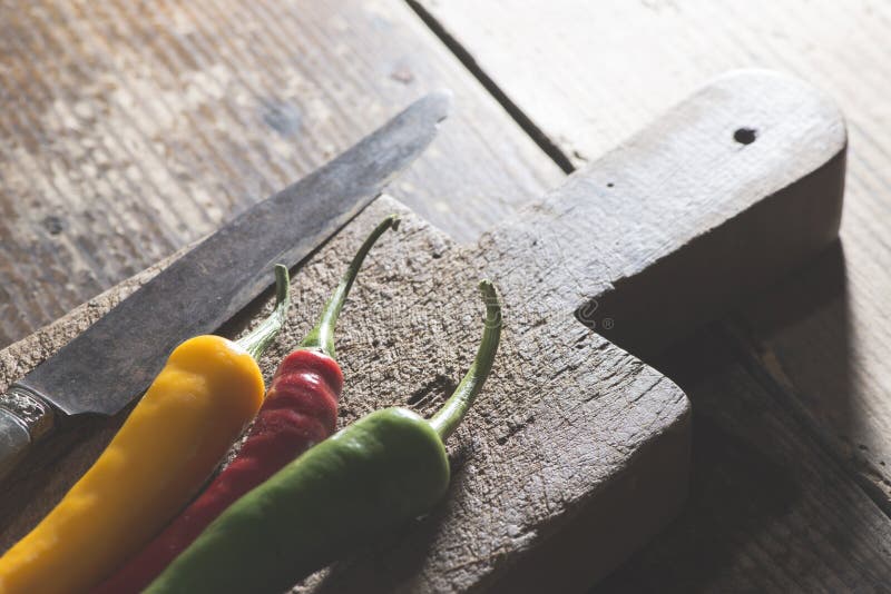 Hot peppers on wooden cutting board royalty free stock photography