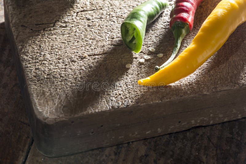 Hot peppers on wooden cutting board royalty free stock photo