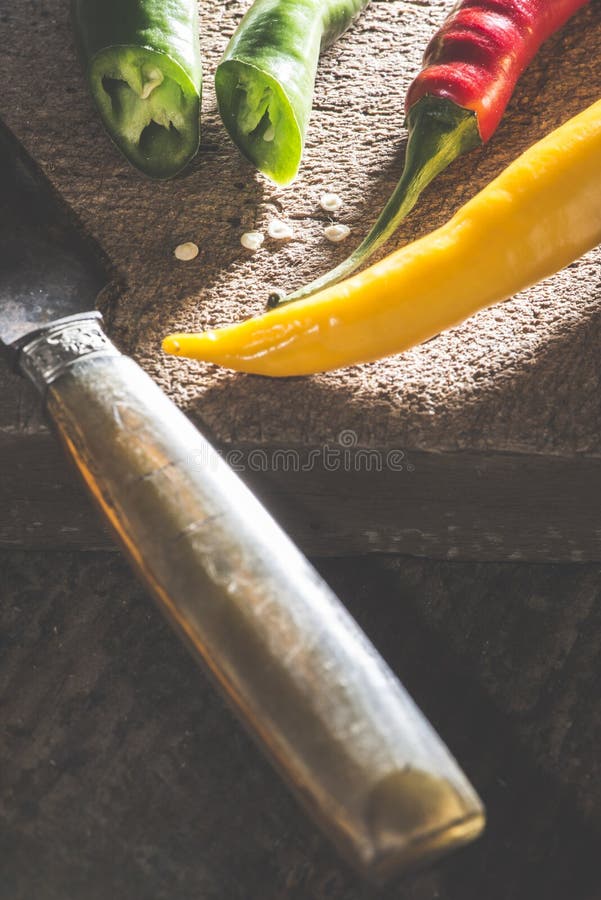 Hot peppers on wooden cutting board royalty free stock photography