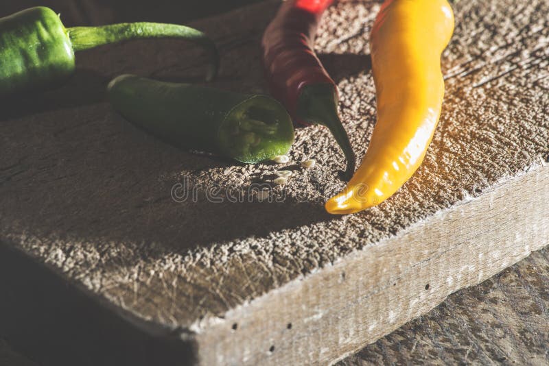 Hot peppers on wooden cutting board stock image