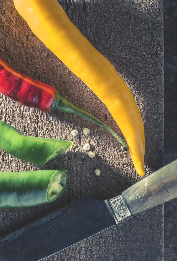 Hot peppers on wooden cutting board stock images