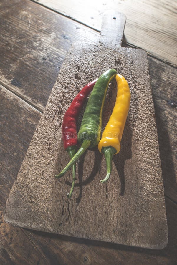 Hot peppers on wooden cutting board royalty free stock photos