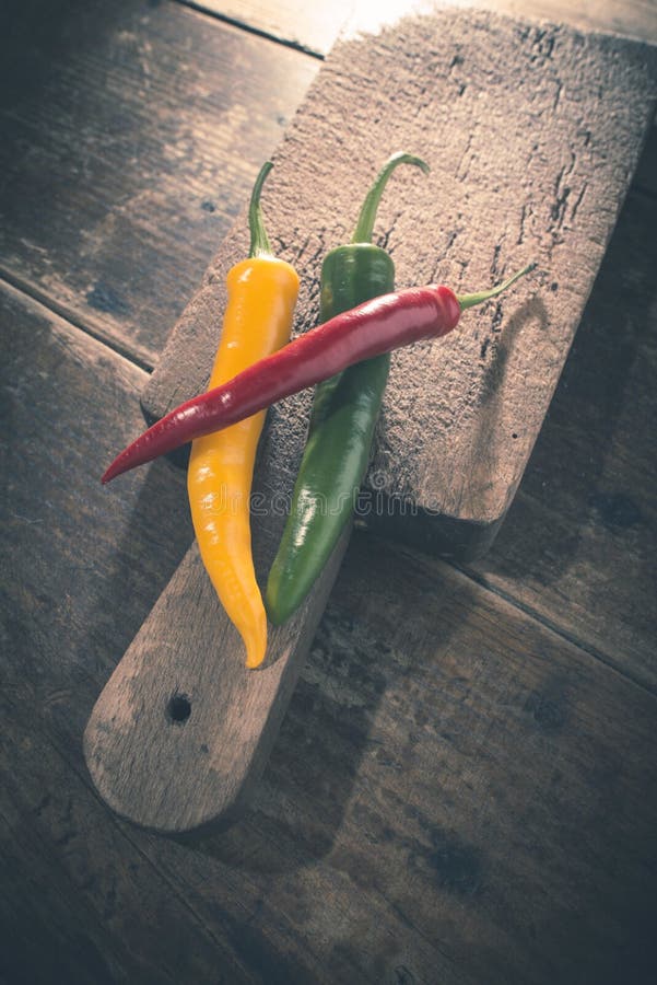 Hot peppers on wooden cutting board stock photography
