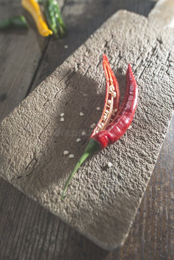 Hot peppers on wooden cutting board stock images