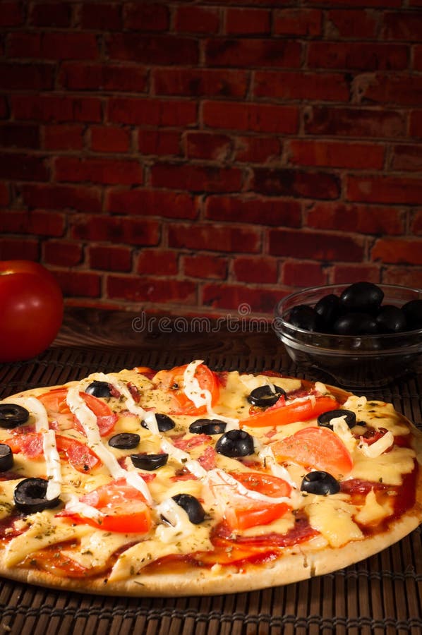 Hot Pizza Slice with Melting Cheese on a Rustic Wooden Table Stock