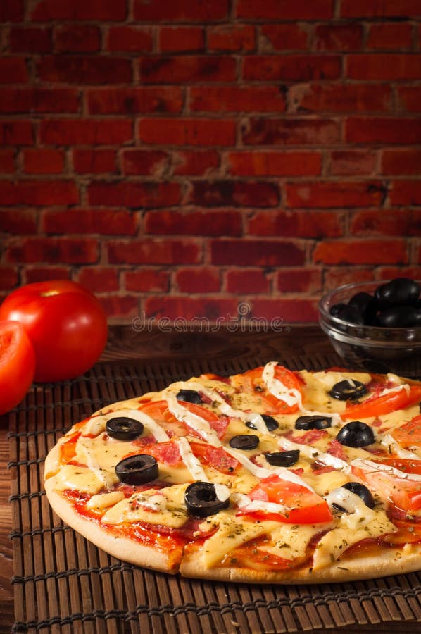 Hot Pizza Slice with Melting Cheese on a Rustic Wooden Table Stock