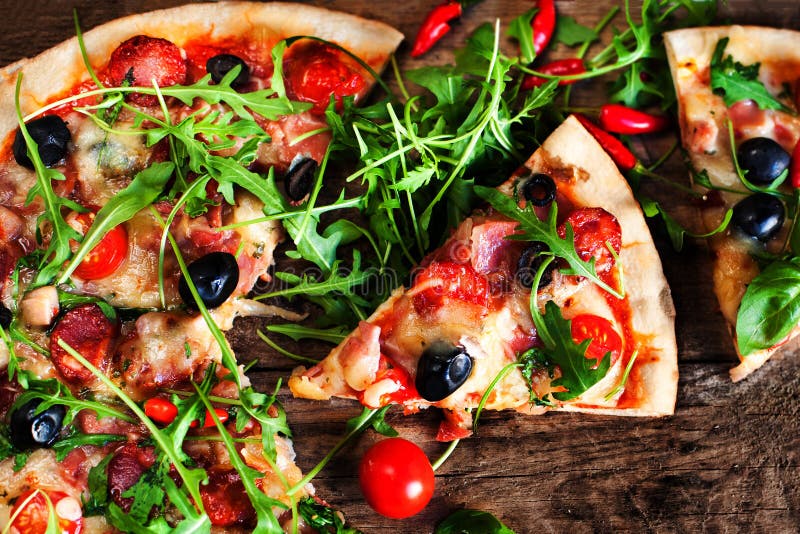 Hot pizza slice with Pepperoni, melting cheese on a rustic wooden table close up. stock image Hot pizza slice with Pepperoni, melting cheese on a rustic wooden table close up. stock image