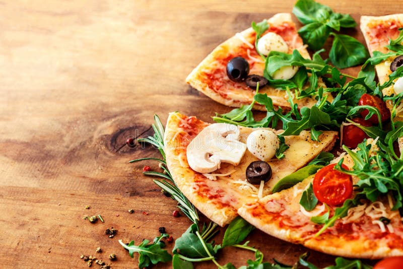 Hot pizza slice with Pepperoni, tomatoes, melting cheese on a rustic wooden table close up. Copy space royalty free stock photos Hot pizza slice with Pepperoni, tomatoes, melting cheese on a rustic wooden table close up. Copy space royalty free stock photos