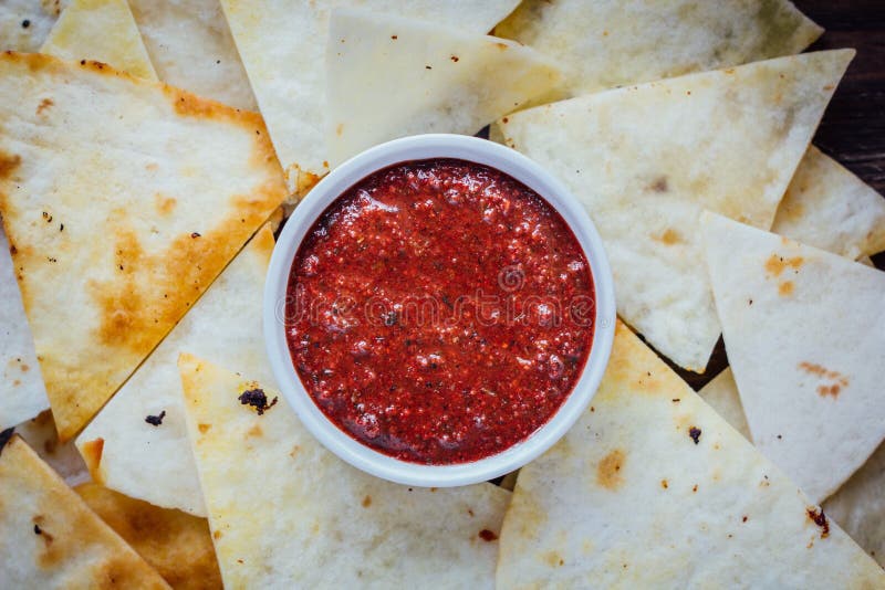 Hot Salsa Dip Over the Hip of Nachos Chips - Organic Home Made Sauce ...