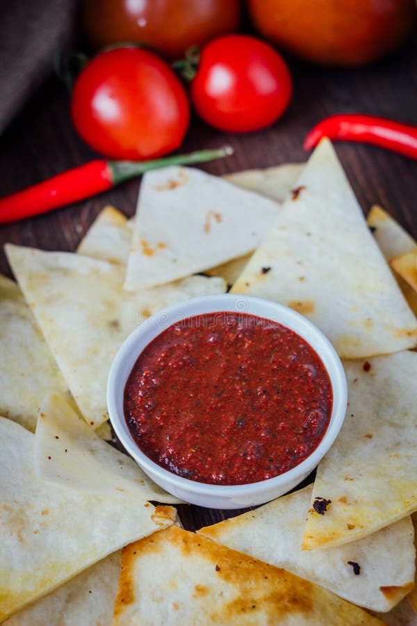 Hot Salsa Dip Over the Hip of Nachos Chips - Organic Home Made Sauce ...