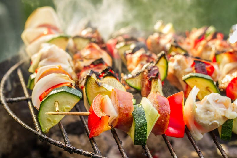 Closeup of hot skewers on the grill with fire. Roasted skewer grill stock images, royalty-free photos and pictures
