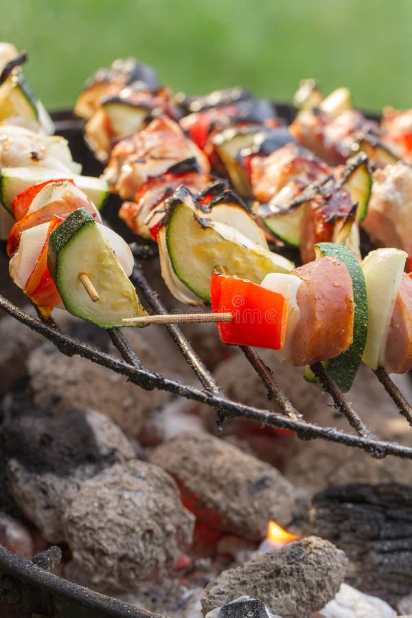 Closeup of hot skewers on the grill with fire. Roasted skewer grill stock images, royalty-free photos and pictures