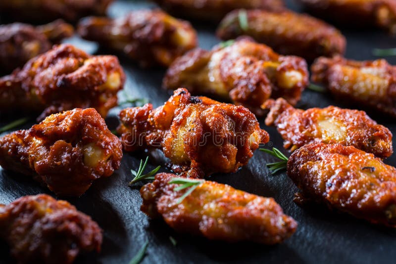 Hot And Spicy Chicken Wings On Dark Background