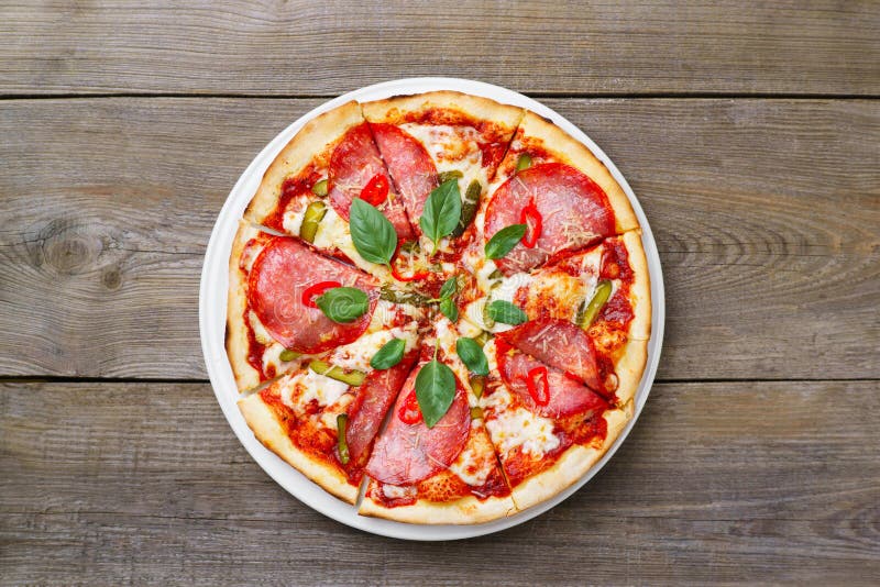 Hot spicy Italian pizza with salami and gherkins royalty free stock image Hot spicy Italian pizza with salami and gherkins royalty free stock image