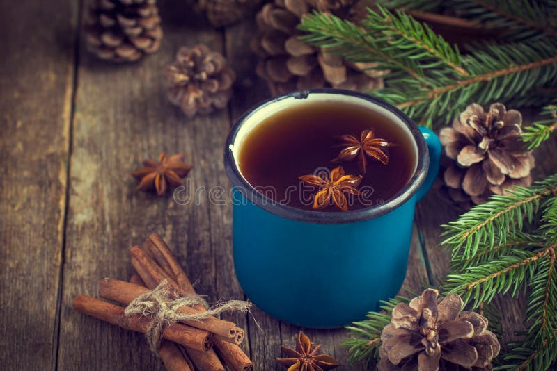 Hot spicy tea with anise and cinnamon in vintage blue enamel mug