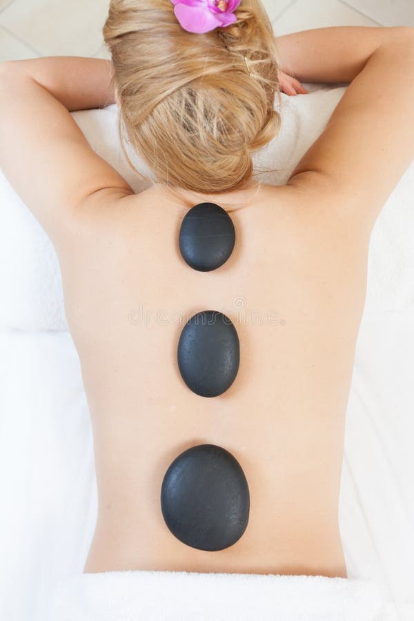 Hot stone massage stock photo. Image of luxury, beauty 49719740