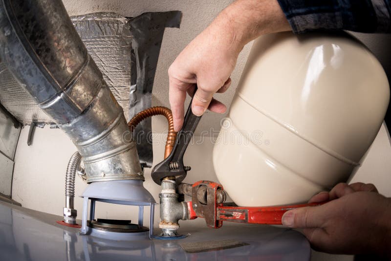 Plumber Uses a Pipe Wrench To Work on the Top of a Hot Water Heater Stock Image Image of close