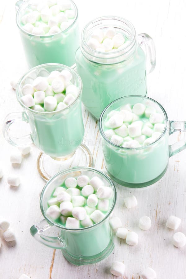 Hot white mint chocolate with marshmallows, white background. Holidey drink royalty free stock image