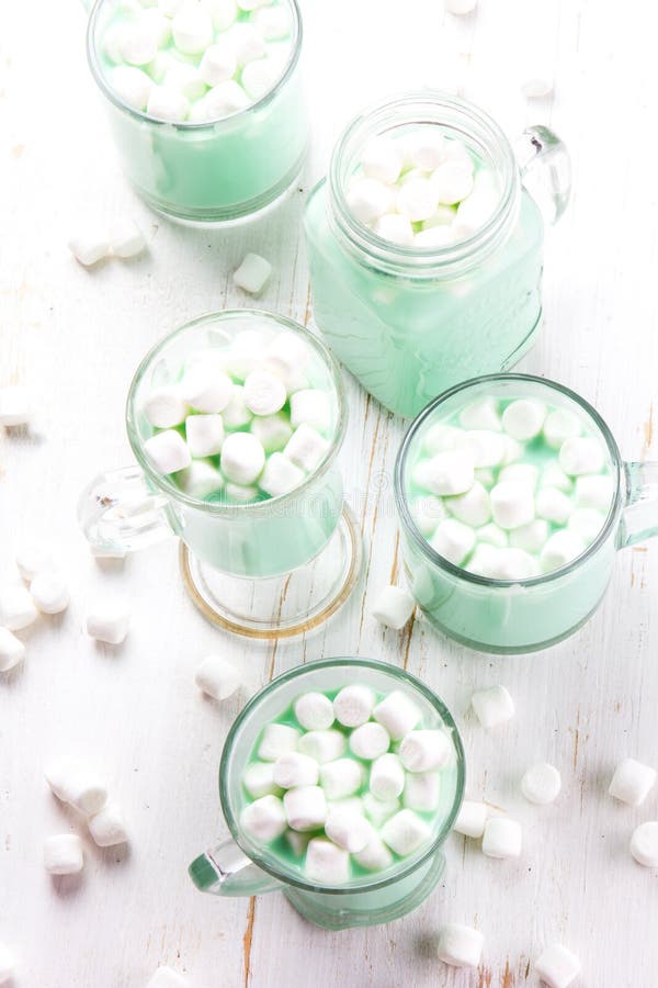 Hot white mint chocolate with marshmallows, white background. Holidey drink stock photography