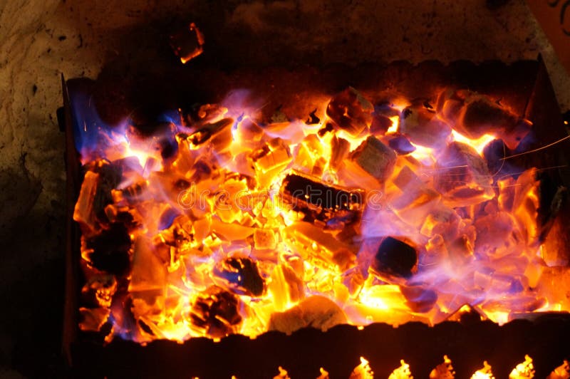Hot Wood Coals Burn with Bright Flame in Iron Brazier Stock Photo