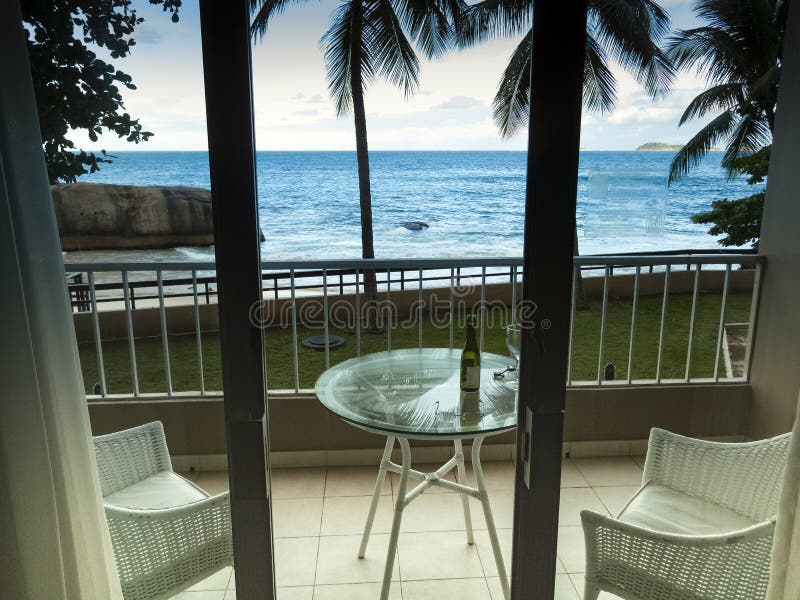 Hotel balcony overlooking ocean and palm trees in Rio de Janeiro