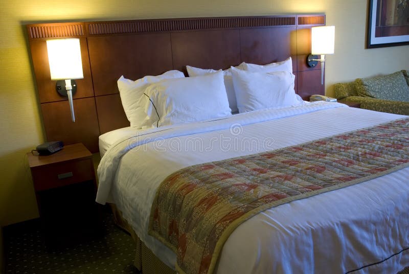 Hotel bed and lamps stock image. Image of motel, pillows 2282619