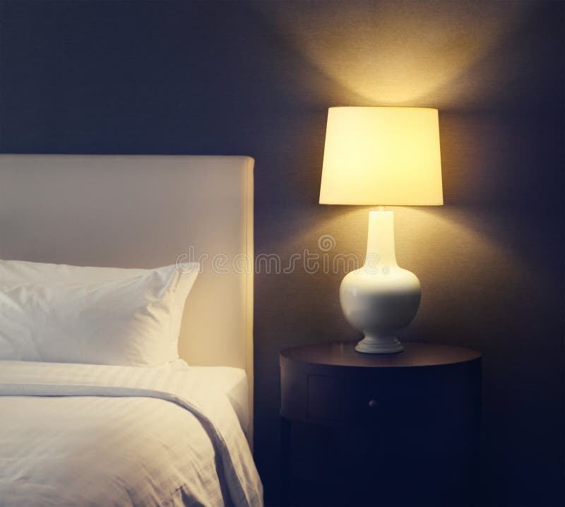 Hotel bedroom with lamp and hotel bed with space for text