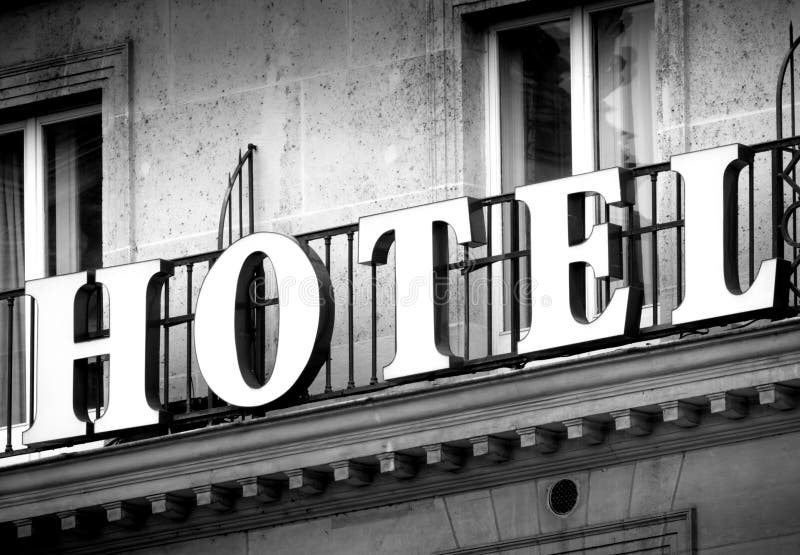 Hotel logo sign in black and white on a vintage building neon. Hotel logo sign in black and white on a vintage building neon