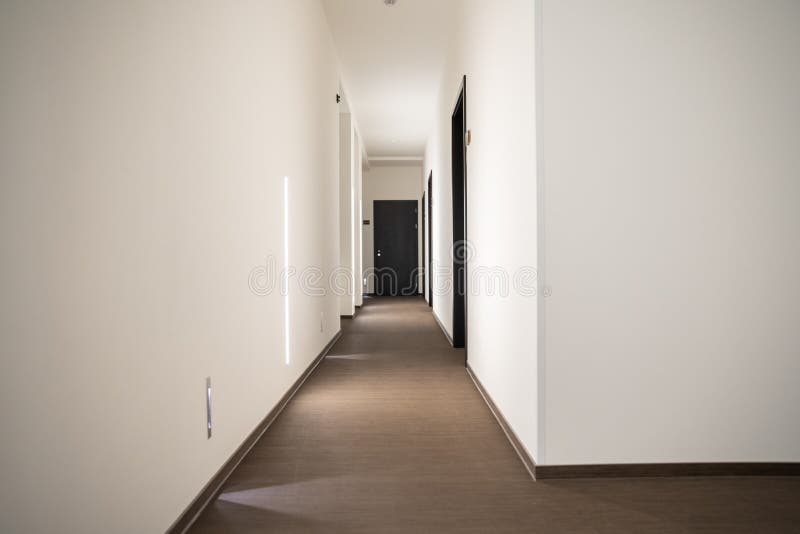 White Hotel Hallway with Many Doors and Lights Stock Image Image of