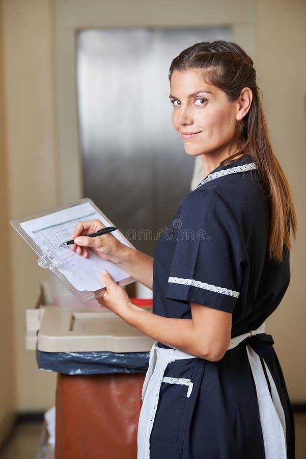 Hotel maid with quality checklist stock images