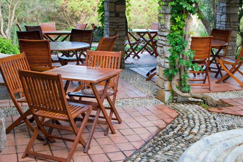 Hotel patio with tables and chairs.