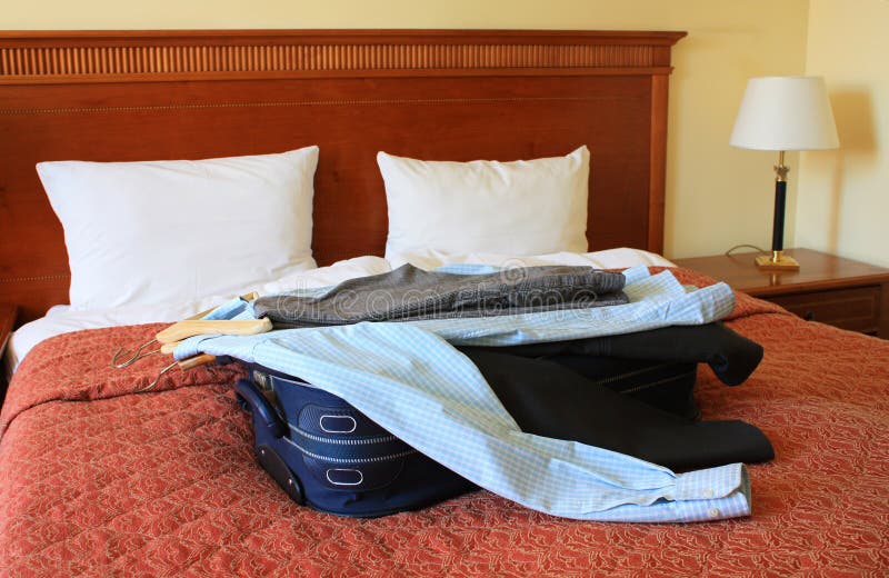 Hotel room with suitcase and clothes royalty free stock image