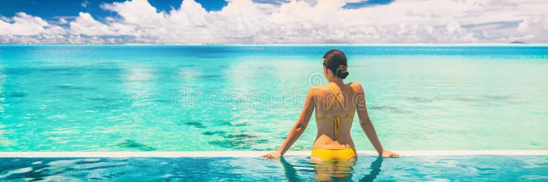 Hotel swimming pool luxury travel vacation summer holiday panoramic banner background with woman in bikini enjoyin sun