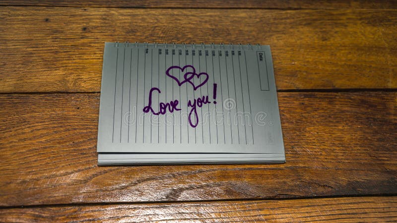 Love you, writing love text on paper, lovely message. Text on spiral agenda. Romantic, love concept. Valentine`s day. Love you, writing love text on paper, lovely message. Text on spiral agenda. Romantic, love concept. Valentine`s day