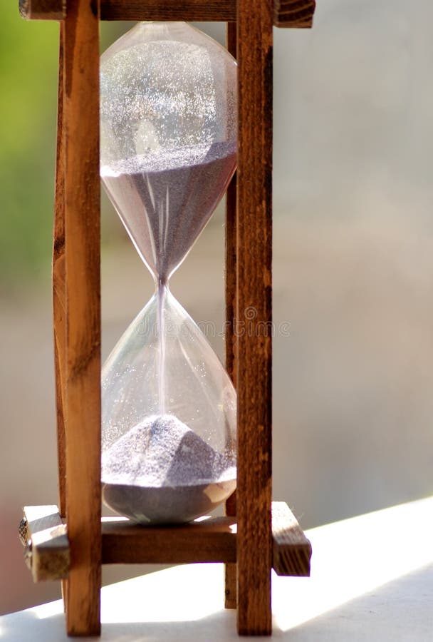 A hourglass isolated on nature background. Biological clock stock images, royalty-free photos and pictures