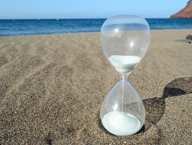 Hourglass on a Beach stock photo. Image of concept, clock - 247082616