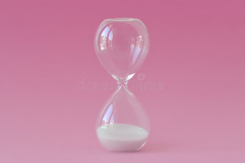 Hourglass on pink background - Concept of infertility and biological clock in women