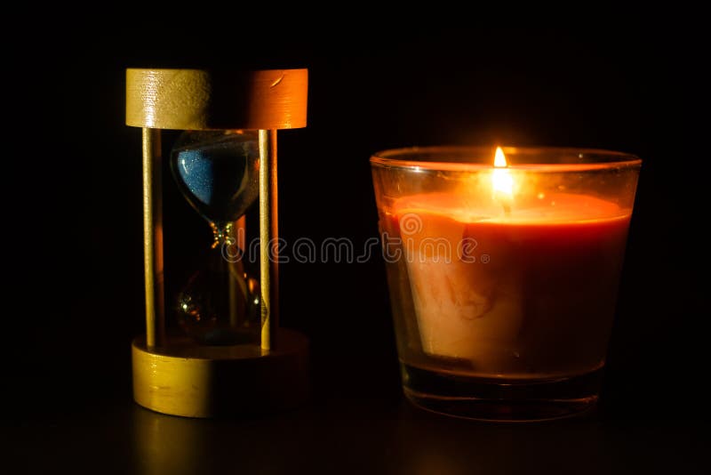 An Hourglass Under the Candle Light. Stock Photo Image of vintage