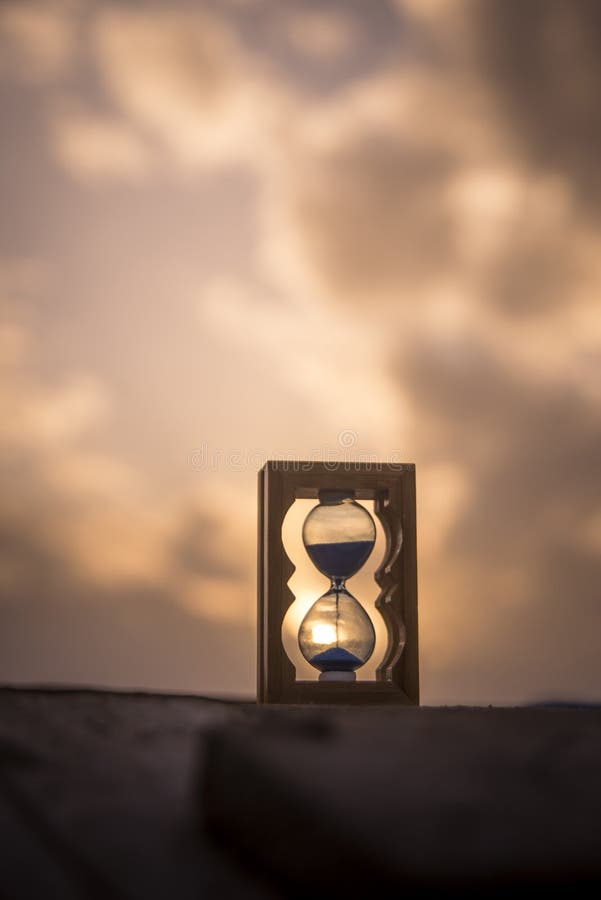 Hourglass on wooden pier.