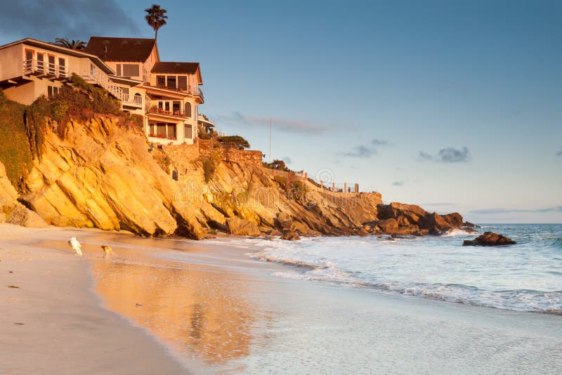 House on cliffs with playing dogs