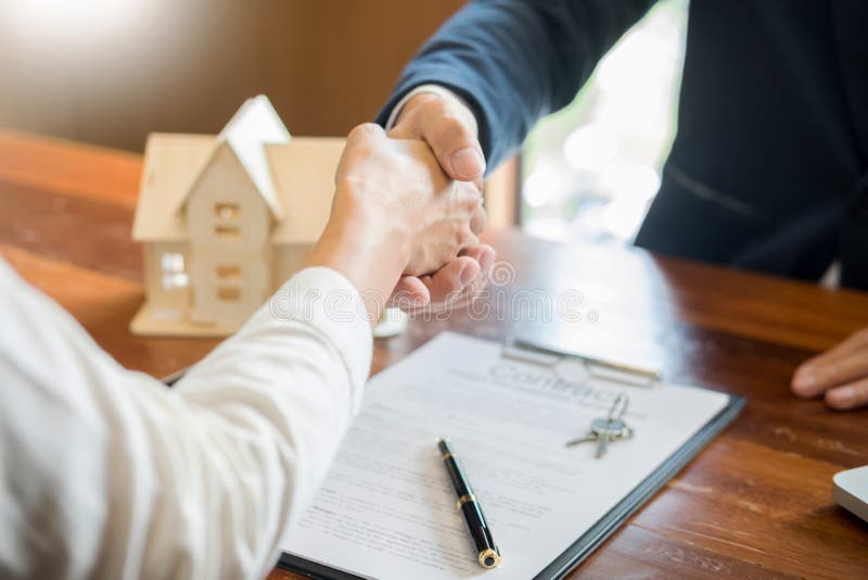 House developers agent or financial advisor and customers shaking hands after signing document making deal as successful.