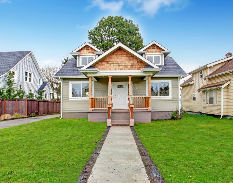 Small house exterior. View of entrance porch with stairs and walkway. Small house exterior. View of entrance porch with stairs and walkway