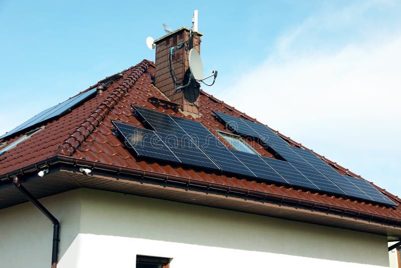 House with Installed Solar Panels on Roof. Alternative Energy Stock