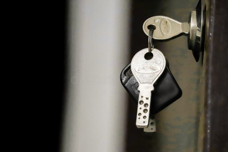 House key in the door,Closeup of an old keyhole with key on a wooden antique door,A key in a lock with house icon on it