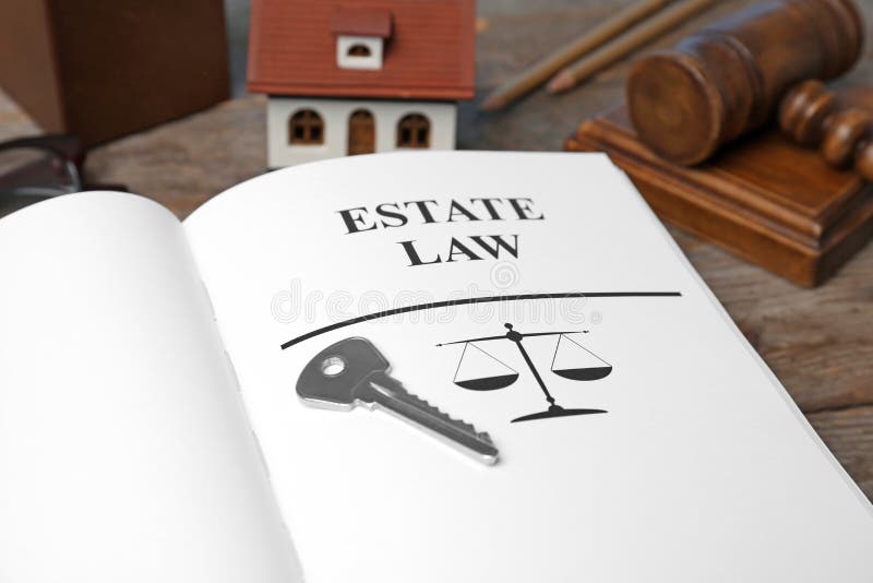 House key and open book with words ESTATE LAW on table, closeup. House key and book with words ESTATE LAW on table, closeup royalty free stock photography House key and open book with words ESTATE LAW on table, closeup. House key and book with words ESTATE LAW on table, closeup royalty free stock photography