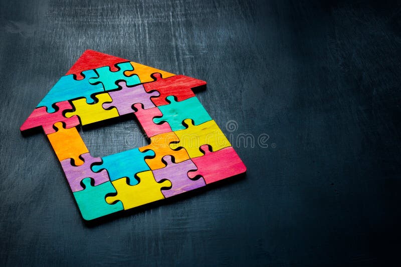A house made up of colorful puzzle pieces. Multiculturalism and unity. stock photo