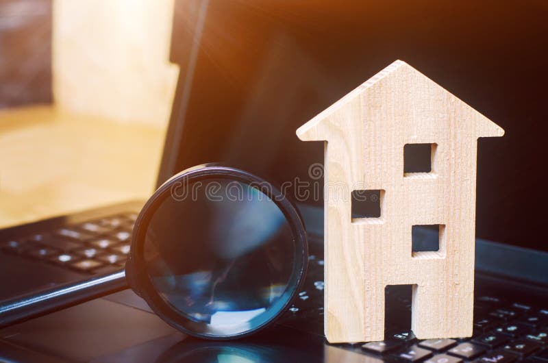 House and magnifying glass on the keyboard. The concept of housing search in the the Internet. Buy an apartment for sale online. stock photo House and magnifying glass on the keyboard. The concept of housing search in the the Internet. Buy an apartment for sale online. stock photo