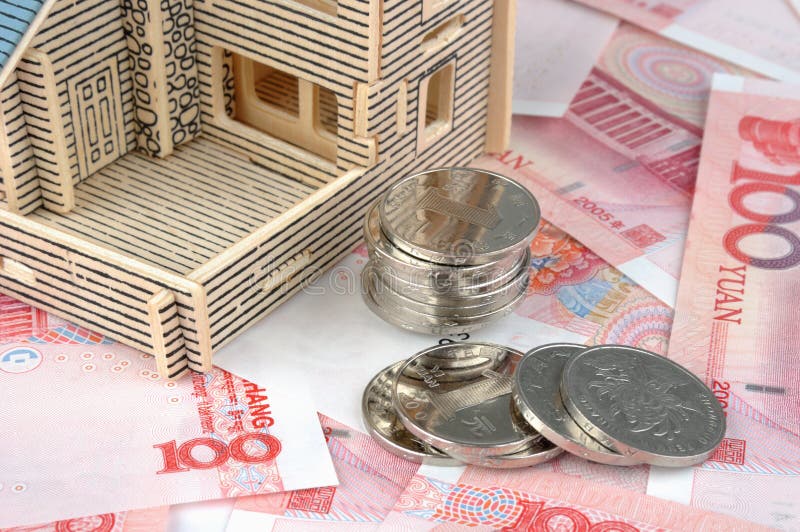 House model with banknote and coins