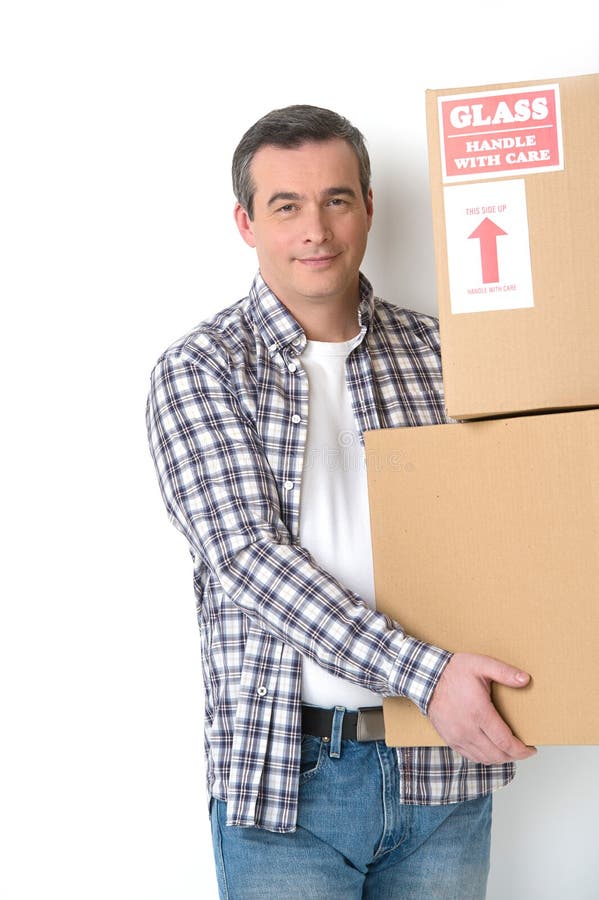 Moving House. Full Length of Young Deliveryman with a Hand Truck Stock