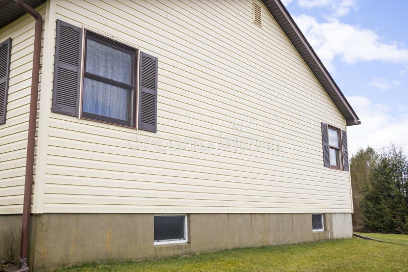 House with pale yellow vinyl siding